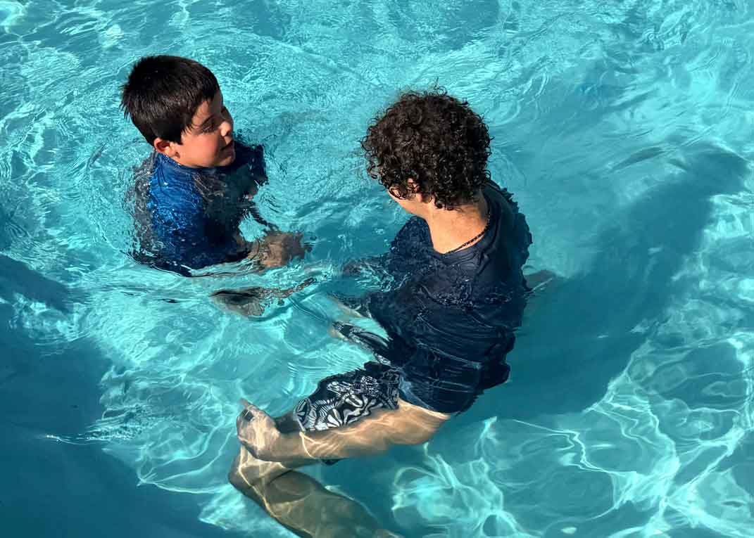 Instructor working one-on-one with a young swimmer
