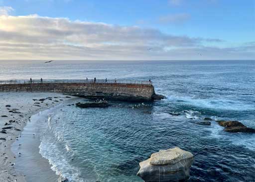 La Jolla Cove coastline at sunset with rocky shoreline and ocean waves, representing ClearHaven Swim service area